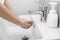 Woman use soap and washing hands under the water tap for corona virus prevention