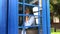 Woman use street payphone