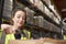 Woman uses barcode reader in a warehouse, head and shoulders