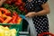 A woman uses biodegradable plastic food bags to buy fruits and vegetables from the supermarket