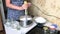 A woman uses a blender to puree blueberries and sugar. Making blueberry jam at home. Preservation and preparation of blueberries