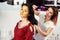 Woman uses darsonval for massage head`s skin in beauty salon