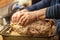 Woman uses her hands to de-bone a Thanksgiving turkey, removing the meat from bones. Selective focus, on one hand