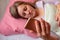 Woman uses mobile phone in a bed. Middle aged 40 years woman lying on pillow and read on smartphone. Social networking or internet