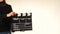 Woman uses movie clapper board, on white