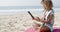 Woman Uses Touchpad Tablet On The Beach