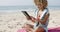 Woman Uses Touchpad Tablet On The Beach