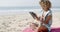 Woman Uses Touchpad Tablet On The Beach