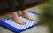 Woman is using acupuncture applicator mat