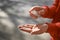 Woman using antibacterial hand sanitizer outdoors, closeup