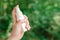 Woman using antiseptic spray outdoors