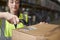 Woman using barcode reader on a box in a warehouse, detail