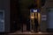 Woman using a Bell Canada Payphone in Montreal in the evening under heavy snow.