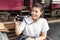 Woman using camera taking pictures in the railway station,alone and wait to travel..Young female wearing white T-shirt with