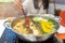 Woman using chopsticks eating japanese shabu. Asian girl keep raw pork with chopstick over hot pot in restaurant. delicious shabu