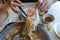 Woman using chopsticks to pick noodles in Chinese hotpot