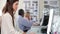 Woman Using Computer At Desk In Busy Creative