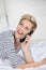 Woman Using Cordless Phone While Looking Up In Bed