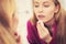 Woman using cotton pad to remove make up