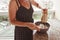 Woman using electric mixer for preparing cheesecake ingredients