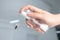 Woman using fly spray in room, closeup