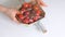 Woman using food film for food storage on a white table. Roll of transparent polyethylene food film for packing products