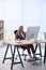 Woman using footrest while working on computer