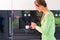 Woman using fully automatic coffee machine