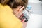 Woman using glue pistol for gift preparation