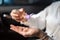 Woman using hand sanitizer in the car for hands disinfection while outdoors