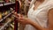 Woman using her phone while grocery shopping