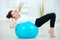 Woman using inflatable gym ball