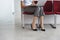 Woman Using Laptop On Chair In Corridor