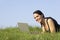 Woman Using Laptop Outdoors In Summer Countryside