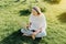 Woman using laptop sitting on the grass