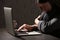 Woman using laptop at table against. Loneliness concept