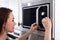 Woman Using Microwave Oven