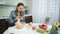 Woman using mobile phone in modern kitchen. Housewife looking for recipe.