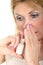 Woman Using Nasal Spray with Hand