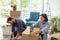 Woman using packing machine, taping the boxes for moving house