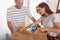 Woman using packing machine, taping the boxes while moving house