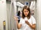 Woman using phone in subway car