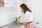 Woman using plunger in sink