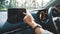 A woman using and pointing finger at navigation screen while driving car