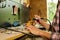 Woman using power working grinder machine, female hand grinds a metal nuts