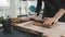 Woman using rolling pin on clay