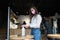 Woman using sanitizer gel cleans hands of coronavirus virus at cafe.