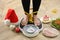 Woman using scale surrounded by food and alcohol on floor, closeup. Overweight problem after New Year party