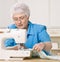 Woman using sewing machine at home