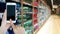 Woman using smart phon in supermarket